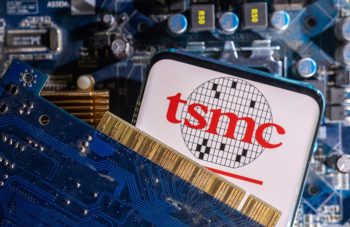 A smartphone with a displayed TSMC (Taiwan Semiconductor Manufacturing Company) logo is placed on a computer motherboard in this illustration taken March 6, 2023. REUTERS/Dado Ruvic/Illustration - RC2KOZ959H42